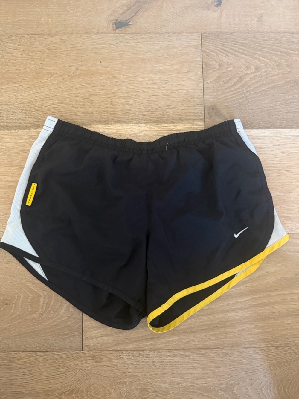 Nike Black Running Shorts with White Panels and Yellow Hem